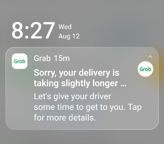 Grab phone notification apologising that a food delivery is taking longer